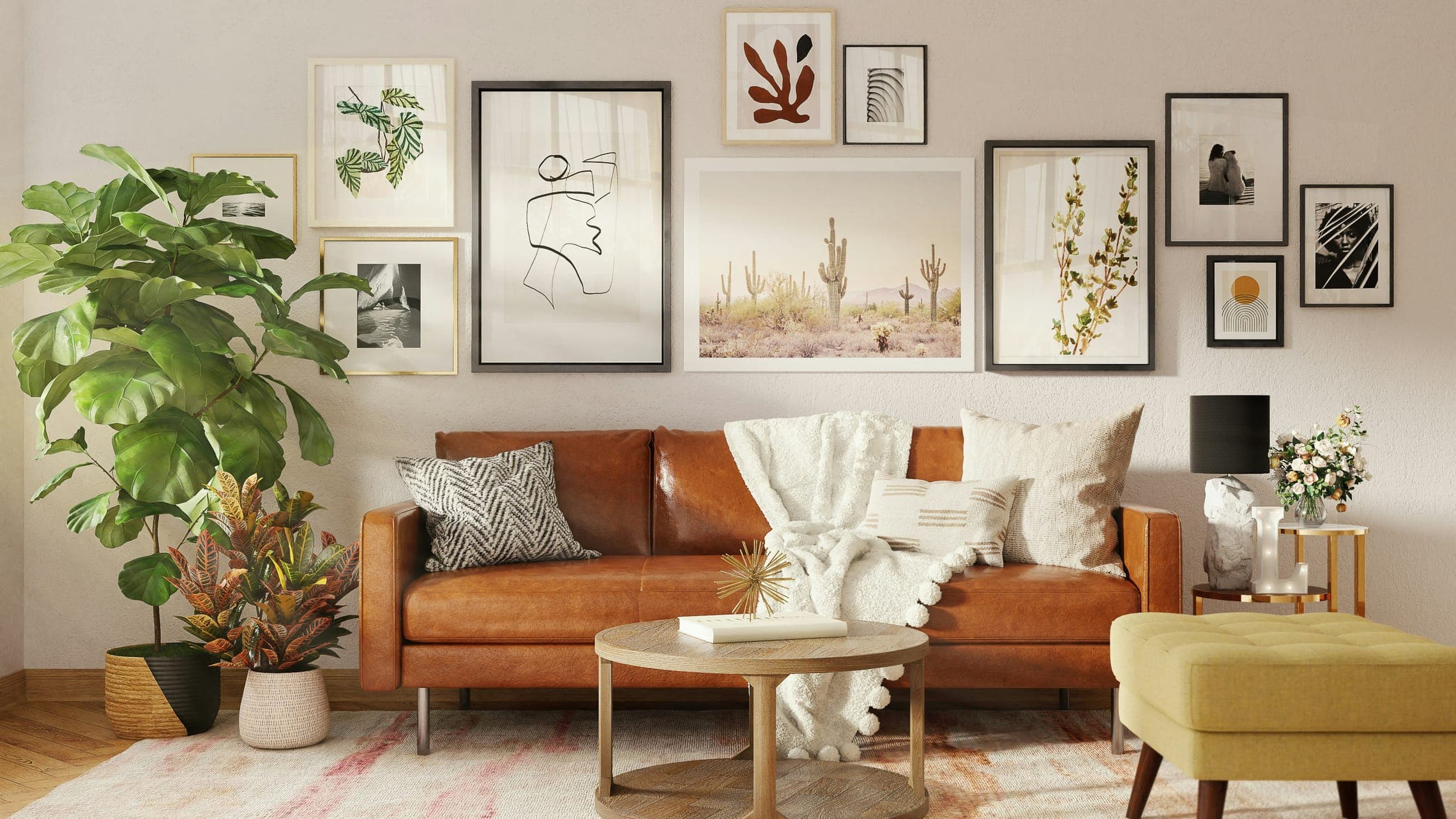 Living room with tan leather sofa, gallery wall of framed prints, fiddle-leaf fig and ottoman.