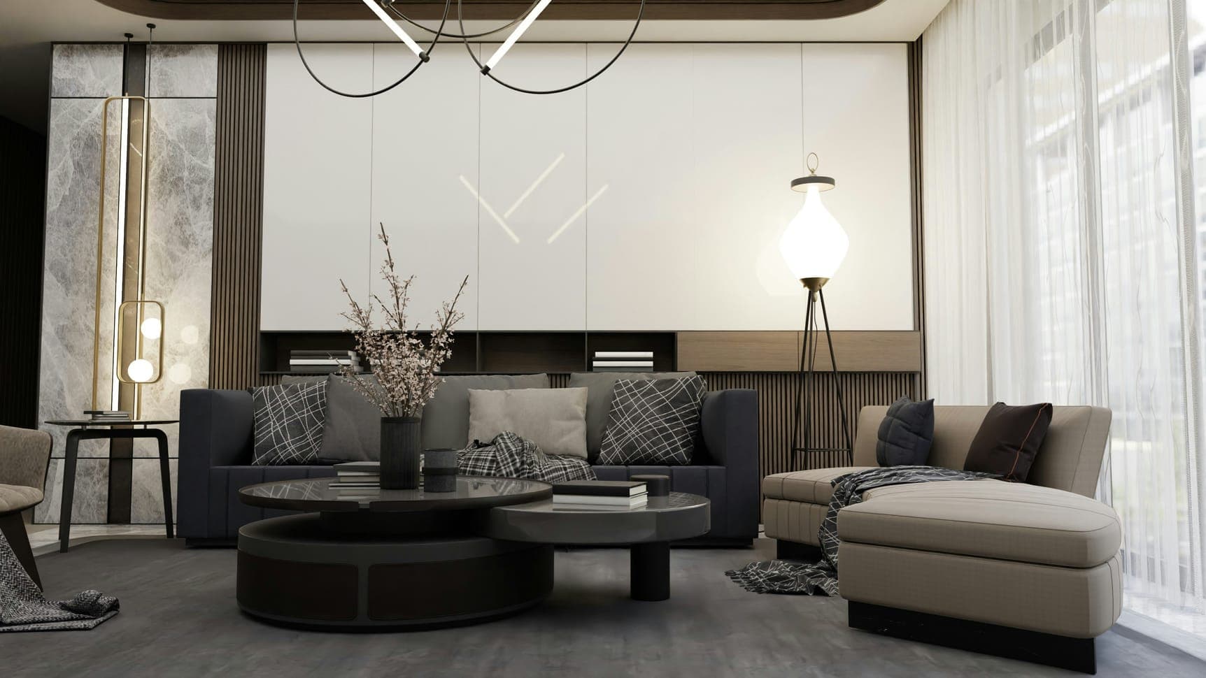 Front view of a living room with grey sofas, plaid cushions, round tables and floor lamp.