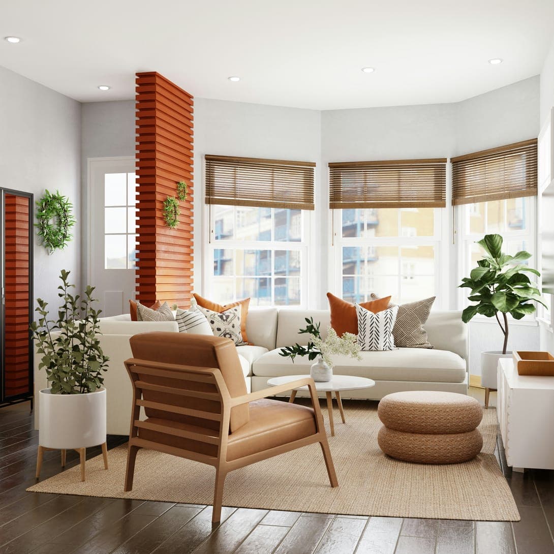 Bright living room with white sofa, leather armchair, bay windows with blinds and plants.